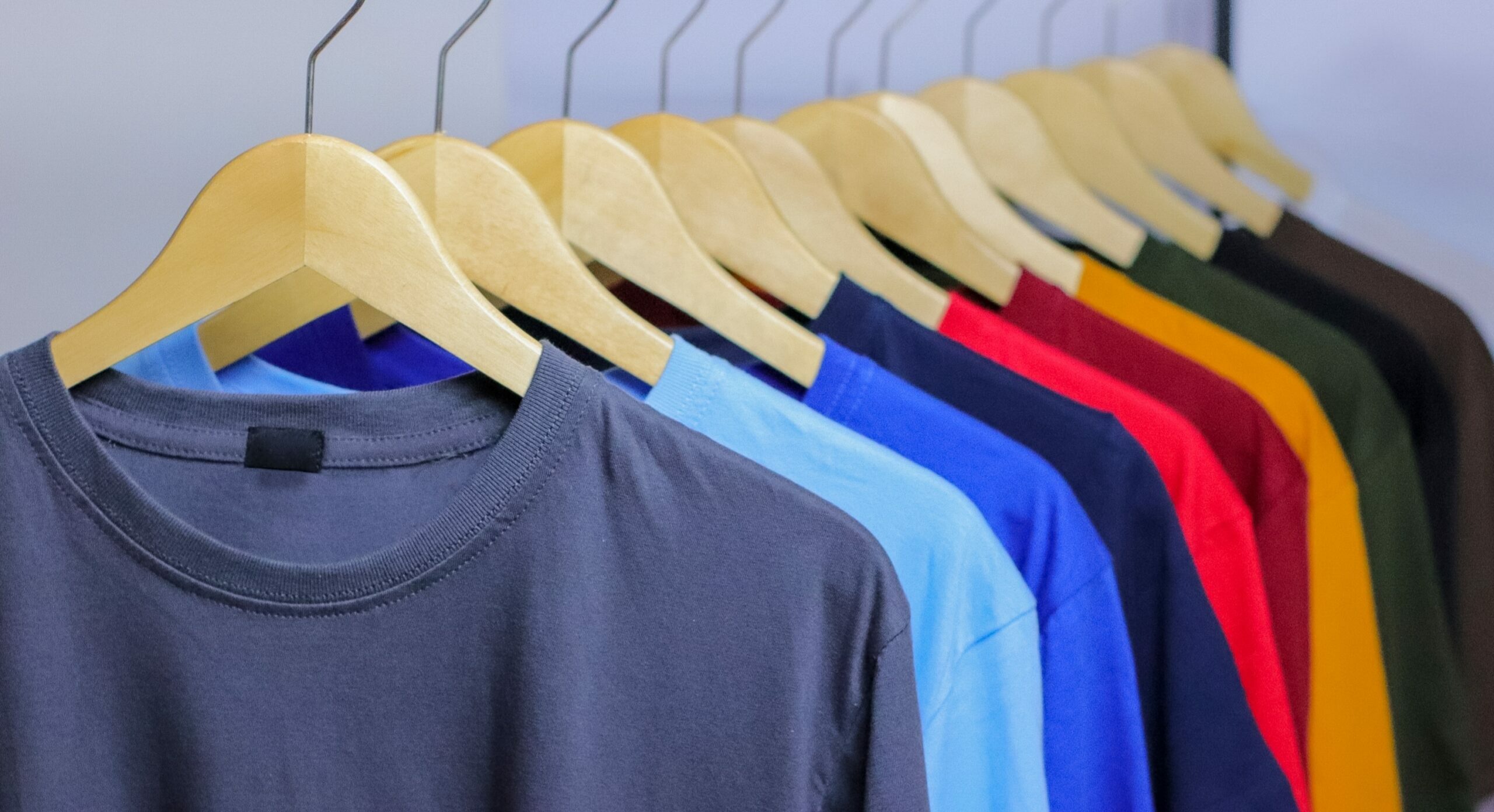 Colorful,T-shirts,On,Wooden,Hanger,Hanging,On,Clothing,Rack